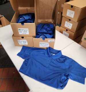 g1011- corner store royal blue cases of shirts - Image 1