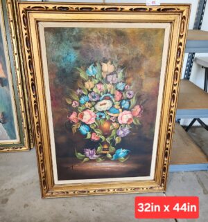 w85- floral still life in an ornate gold frame. Signed