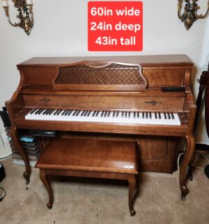 a81- Kawai 802-F upright piano in a medium pecan finish. w/ music