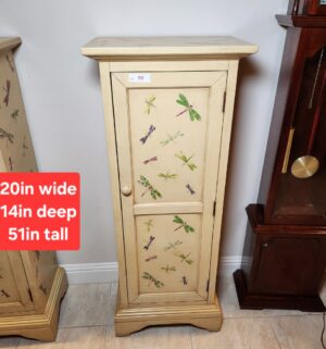 a90- distressed cream-colored wooden single-door accent cabinet with dragonfly decals