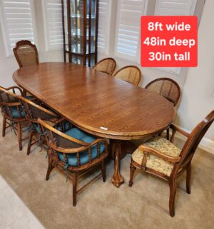 a122- Stunning Oak 8 Chair Dining Table w/ Cane Seat Chairs. Also turns into a round table