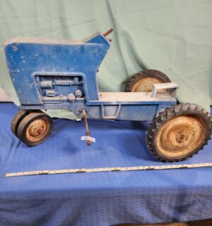 e6- Ertl Ford F-68 pedal tractor, which is a collectible ride-on toy.