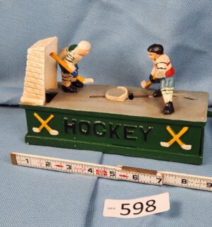 d598- vintage cast metal mechanical hockey coin bank