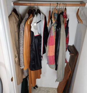 i84- Coats & clothing in entry closet