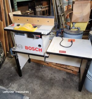 L429- Bosch RA1171 Cabinet-Style Benchtop Router Table. Sold with work bench