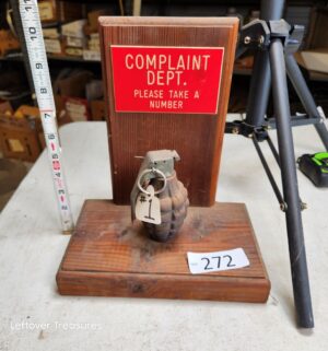 n272- novelty desk sign featuring a gag Complaint Dept. plaque and a non-functional replica grenade