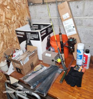 s222- fishing poles, zip ties, misc items on table