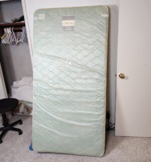 t14- vintage twin mattress kept in plastic