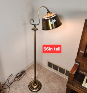 t87- brass color bridge floor lamp with a metal shade