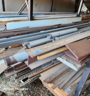 u66- metal pipes, various iron/metal on rack. Some are 16ft long