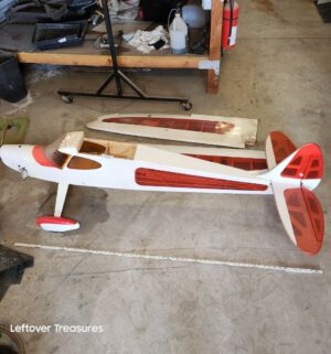 u234- Sig Rascal 110 radio-controlled airplane with a white and red color scheme