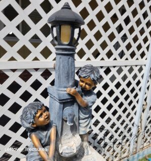 v30- Resin Outdoor Fountain Statue featuring a boy and girl at a water pump with an LED light - Image 3