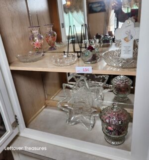 v134- glass dishes in left cabinet