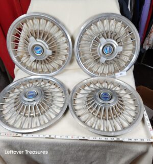 b49- 14-inch Ford wire spinner wheel covers, typically fitting 1963-1967 Mustang, Galaxie, or Falcon models