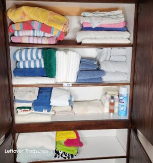 y308- clean towels in cabinet - Image 1