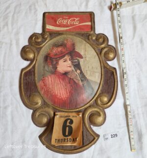b229- 1970s Coca-Cola advertising sign features a 3D molded plastic frame in a gold, rococo style - Image 1