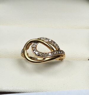 c155- 10k two-tone gold ring features a twisted knot design with pave-set diamonds. Gold/Diamonds Tested
