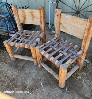 d127- rustic, handmade wooden chairs feature a log frame and a woven leather strap seats
